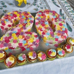a cake in the shape of 20 with colourful icing and lowers